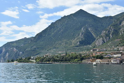 Scenic view of river and mountains against sky