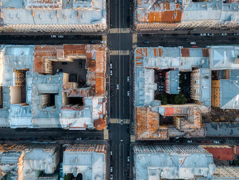 Aerial photo of crossroads of multi-lane roads and roofs of old residential buildings. top down view