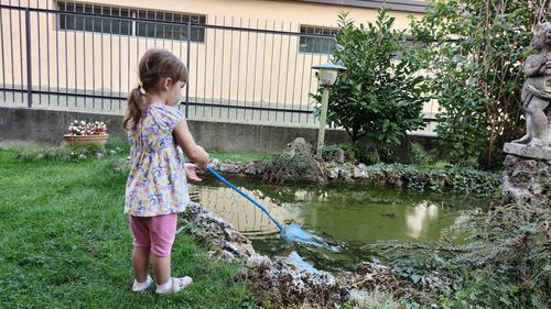 Full length of woman standing by plants