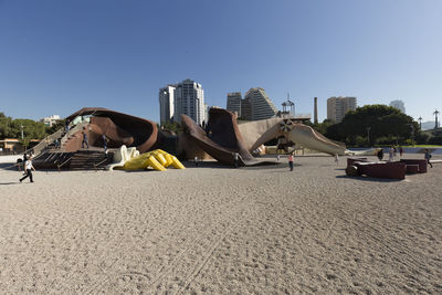 Panoramic view of city against clear blue sky