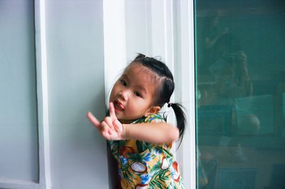 Portrait of cute girl standing in corridor