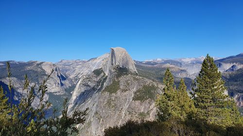 Scenic view of mountains against clear blue sky