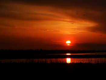 Scenic view of sea against romantic sky at sunset