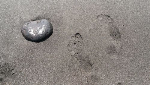 High angle view of footprints on sand