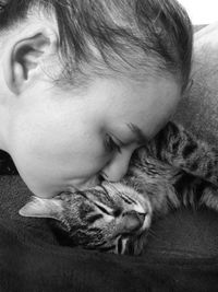 Close-up of woman kissing cat