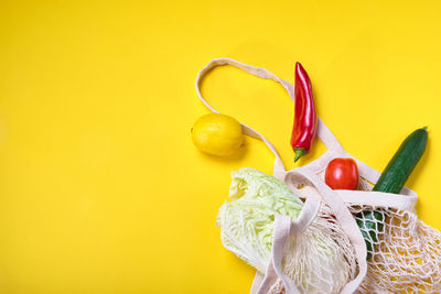 Close-up of yellow chili pepper against orange background