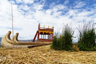 Agricultural field against cloudy sky