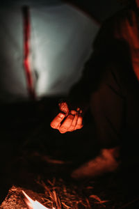 Close-up of hand on fire at night