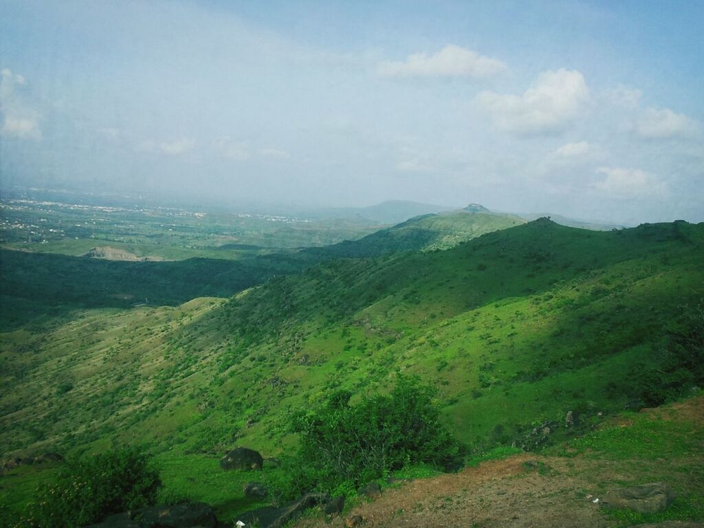 tranquil scene, mountain, landscape, tranquility, scenics, beauty in nature, sky, green color, nature, mountain range, non-urban scene, grass, idyllic, tree, high angle view, hill, remote, growth, cloud - sky, day