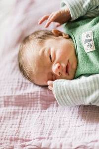 Portrait of cute baby sleeping on bed