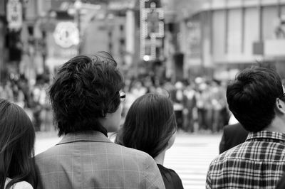 Rear view of woman looking at camera