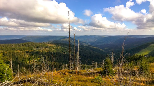 Scenic view of mountains against cloudy sky