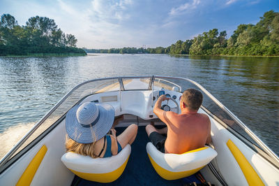 Two people rest on the boat on the river. high quality photo