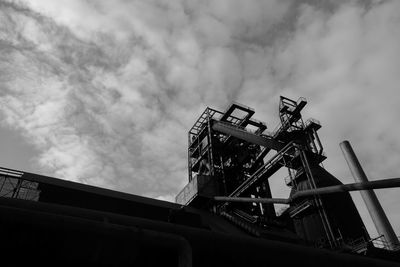 Low angle view of building against cloudy sky