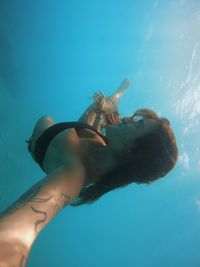 Low section of woman swimming in sea