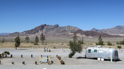 Scenic view of desert against clear blue sky