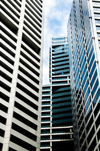 Low angle view of skyscrapers against blue sky