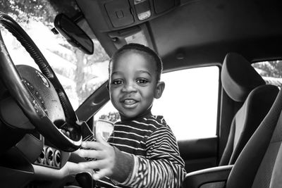 Portrait of smiling boy in car