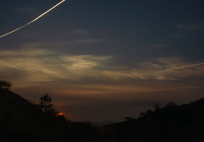 Low angle view of silhouette trees against sky during sunset