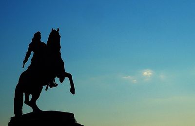 Low angle view of statue against blue sky