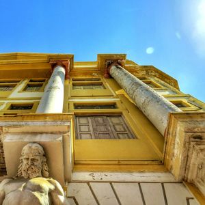 Low angle view of building against blue sky
