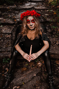 Portrait of beautiful young woman in forest