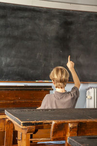 Rear view of boy sitting on bench