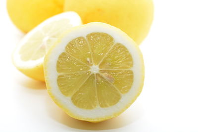 Close-up of lemon slice over white background