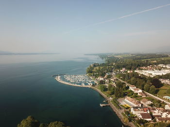 High angle view of bay and cityscape against sky