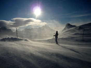 Man walking on snow covered land