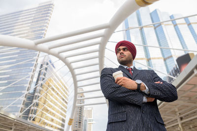 Low angle view of man standing against office building