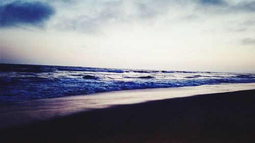 Scenic view of beach against sky during sunset