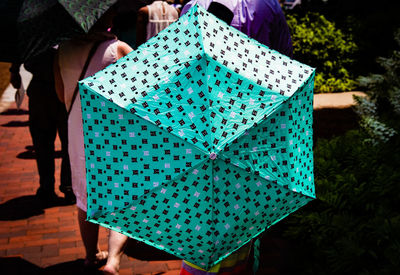 Low section of woman holding umbrella