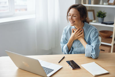 Businesswoman talking on video call at office