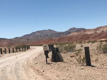 Scenic view of desert against clear blue sky