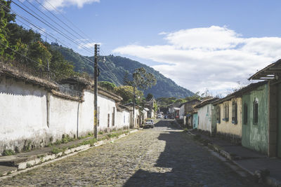 Town of ataco in ruta de las flores, el salvador. empty road with sidewalk and old buildings.