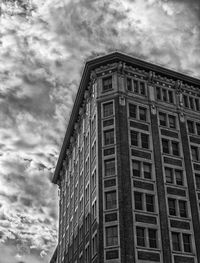 Low angle view of building against cloudy sky