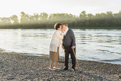 Happy senior couple kissing on the beach