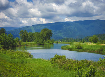 Scenic view of lake and mountains against sky