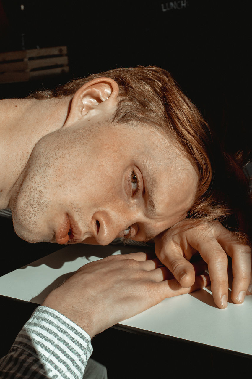 CLOSE-UP PORTRAIT OF YOUNG MAN WITH TATTOO ON HAIR