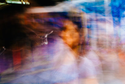 Blurred motion of man on multi colored reflection