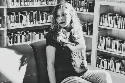 Portrait of young woman sitting in living room