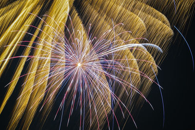 Low angle view of firework display at night