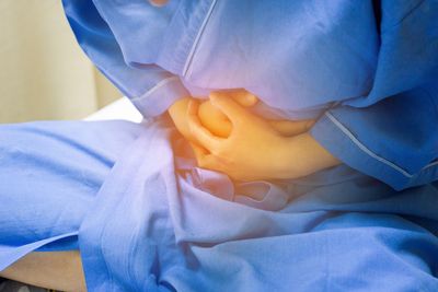 Midsection of patient with stomach pain at hospital