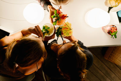 High angle view of people sitting on table