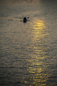 Man in boat sailing on sea