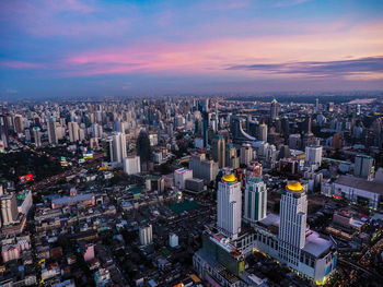 High angle view of illuminated buildings against sky during sunset