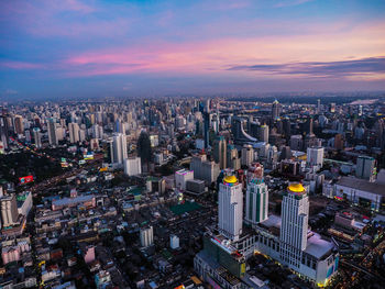 High angle view of illuminated buildings against sky during sunset