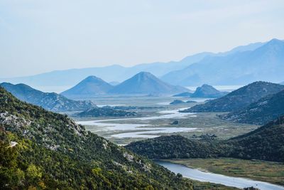 Scenic view of lake and mountains against sky