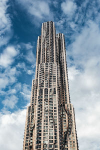 Low angle view of modern building against cloudy sky